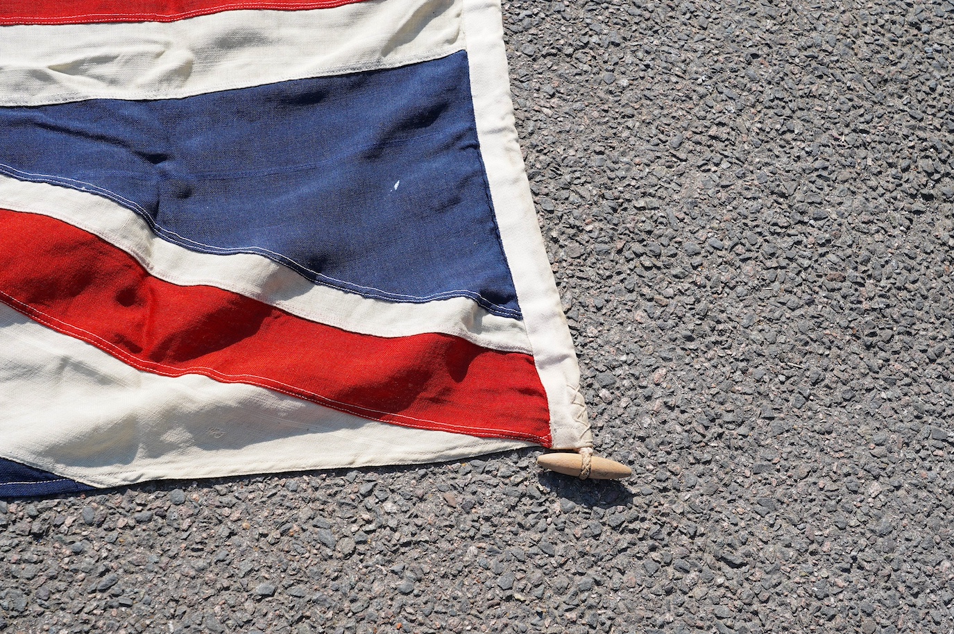 A vintage Union flag, approximately 240 x 120cm, a smaller “Sale” flag and other assorted flags and bunting. Condition - fair